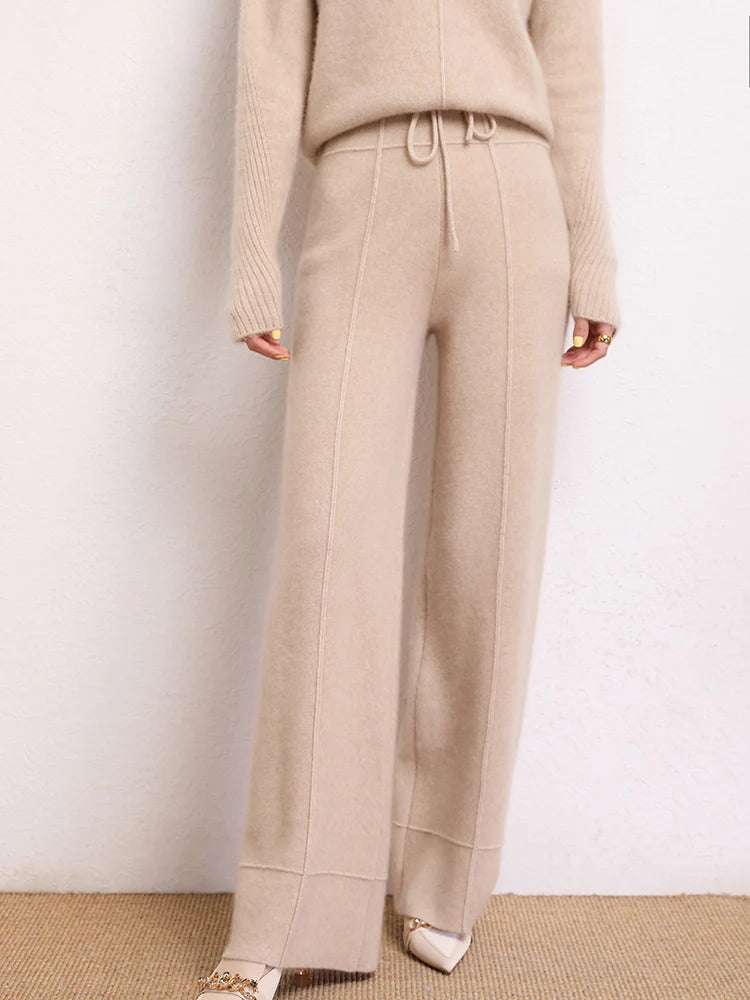 Traced Seaming Cashmere Trousers in Vanilla, model resting leg side — From Borcelleclothes.
