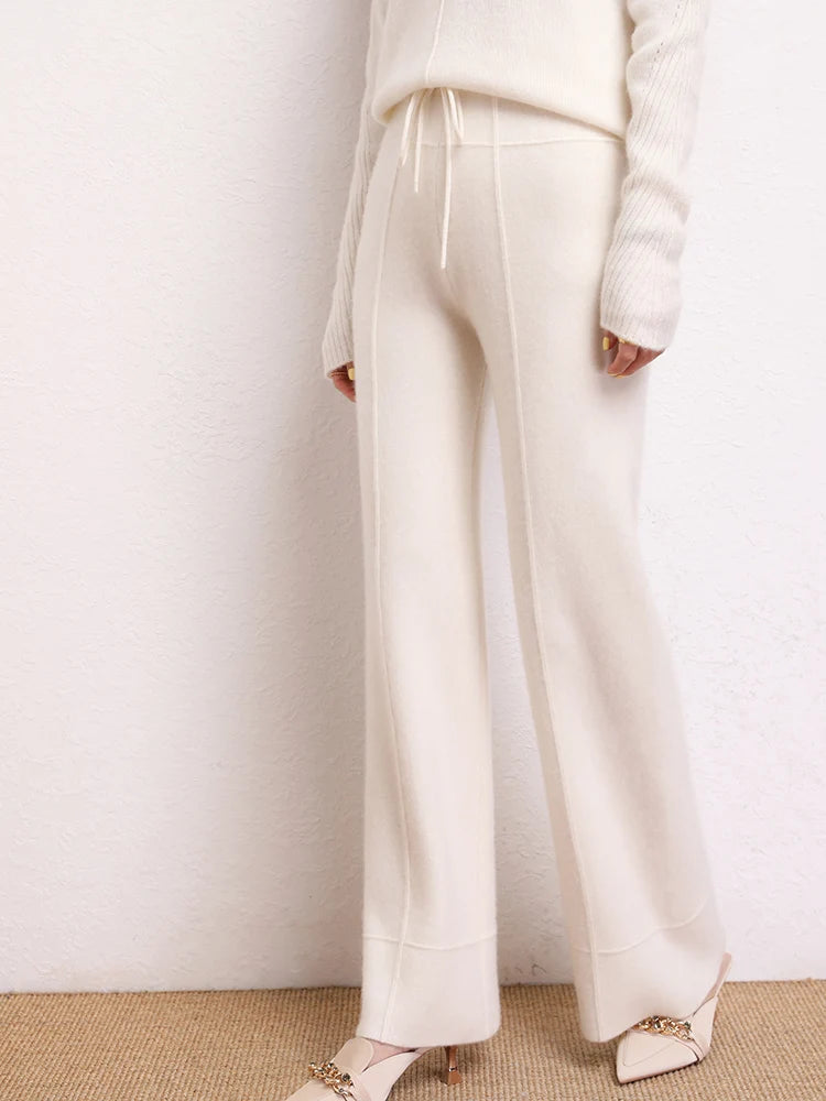Model in Traced Seaming Cashmere Trousers in White Chocolate, turned slightly to the side — From Borcelleclothes.