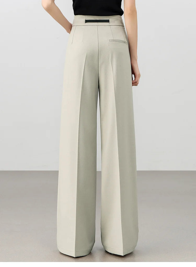 Back view of the foggy grey tailored trousers, highlighting the soft structure and fluid drape. From  Borcelleclothes.