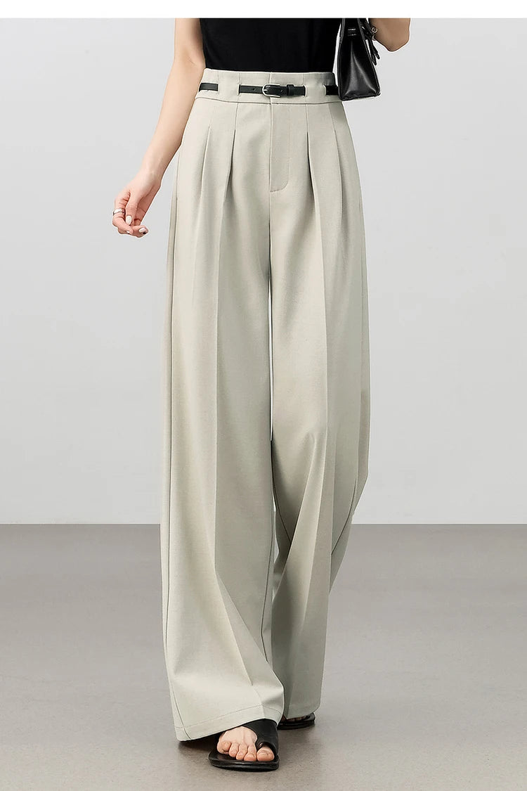 Model stepping forward in foggy grey trousers, showing natural fabric movement and airy silhouette. From Borcelleclothes.