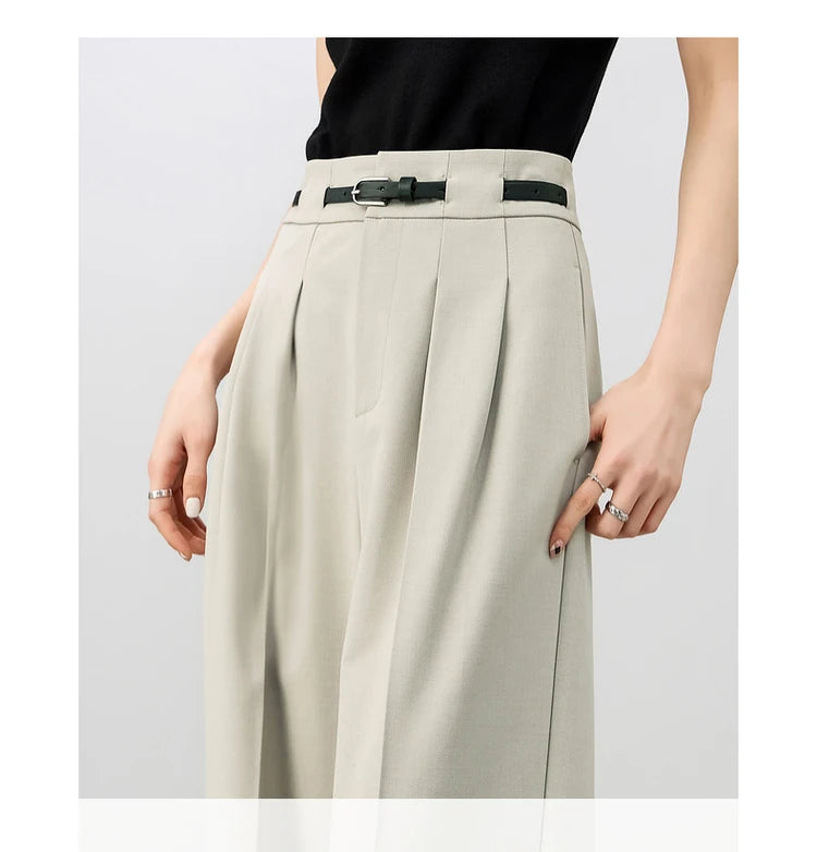 Upper part of the model wearing foggy grey trousers, styled with a black top for contrast and balance. From Borcelleclothes.