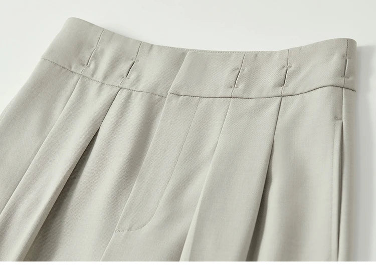 Detail of partial waistband casings on foggy grey trousers, showing minimalist tailoring and styling versatility. From Borcelleclothes.