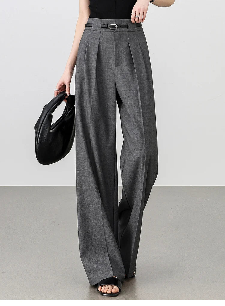Model holds a bag while wearing storm dust trousers, emphasizing versatility in a clean, polished look. From Borcelleclothes.