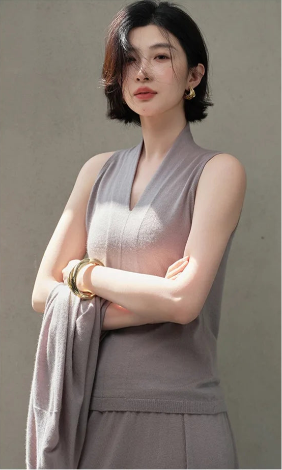 Model crossing arms in the Morning Mist V-neck cashmere top — From Borcelleclothes.