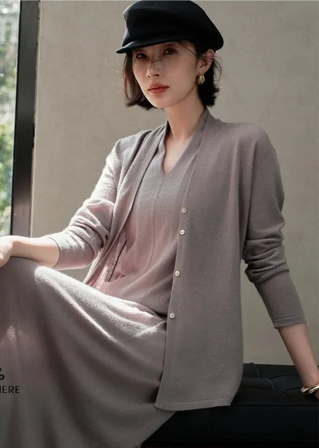 Model in Morning Mist V-neck cashmere top sitting on a sofa — From Borcelleclothes.