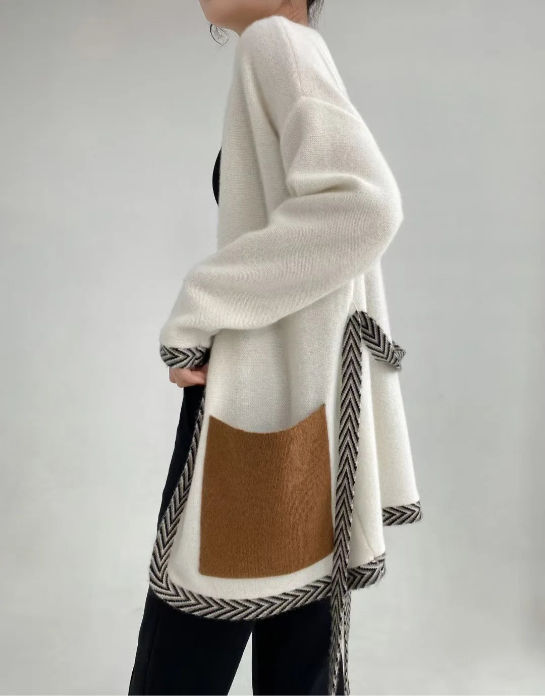 Model wearing the Whispering Smoke cashmere cardigan viewed from the side, showing the soft drape and relaxed silhouette — From Borcelleclothes.