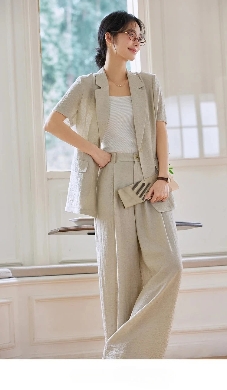 Woman in the Wild Sand set with legs crossed, portraying calm confidence. From Borcelleclothes.