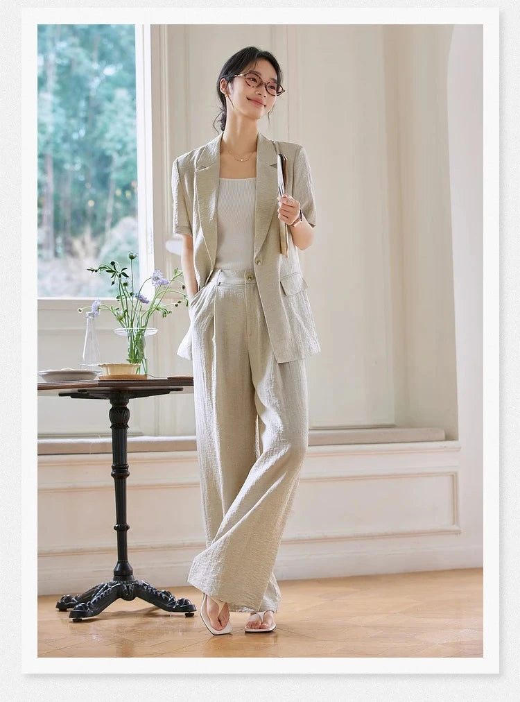 Woman wearing the Wild Sand two-piece set with hand in trouser pocket, standing confidently. From Borcelleclothes.