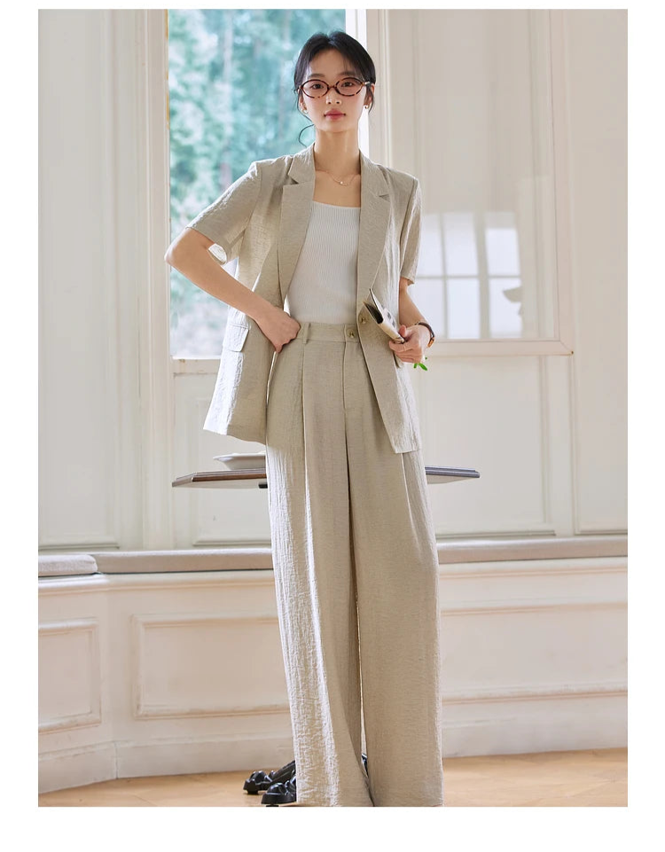 Close-up of the model’s hand resting on her waist, showcasing the trousers’ tailored fit. From Borcelleclothes.