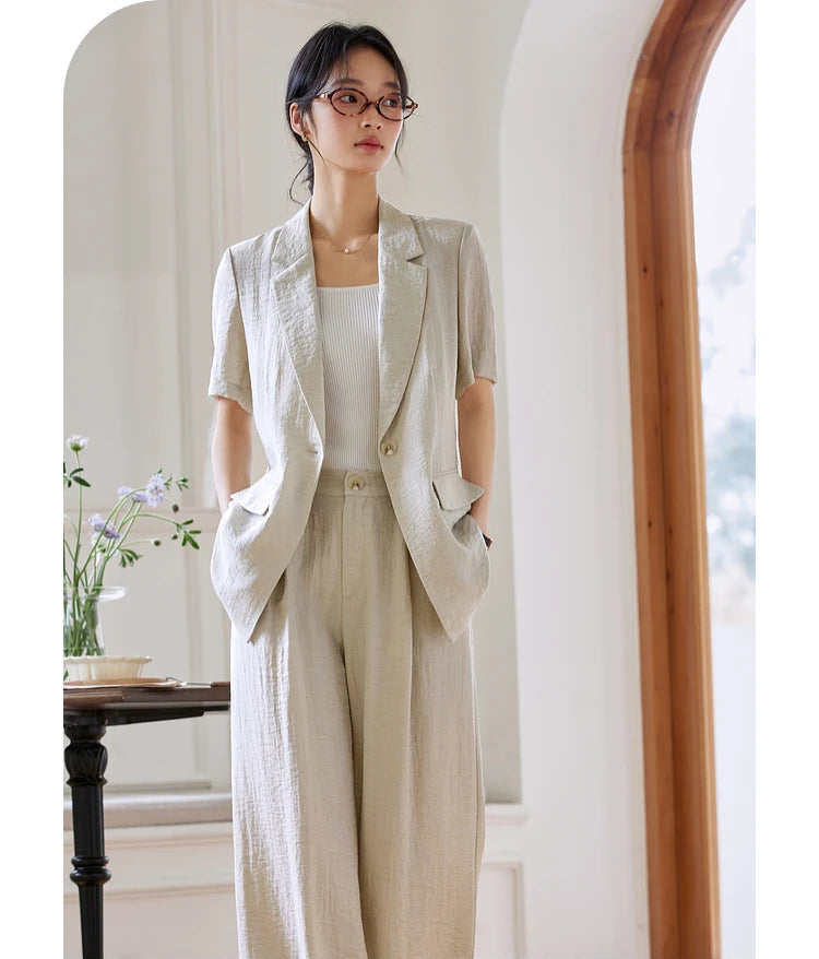 Woman wearing the Wild Sand two-piece set with hands in trouser pockets, standing confidently. From Borcelleclothes.
