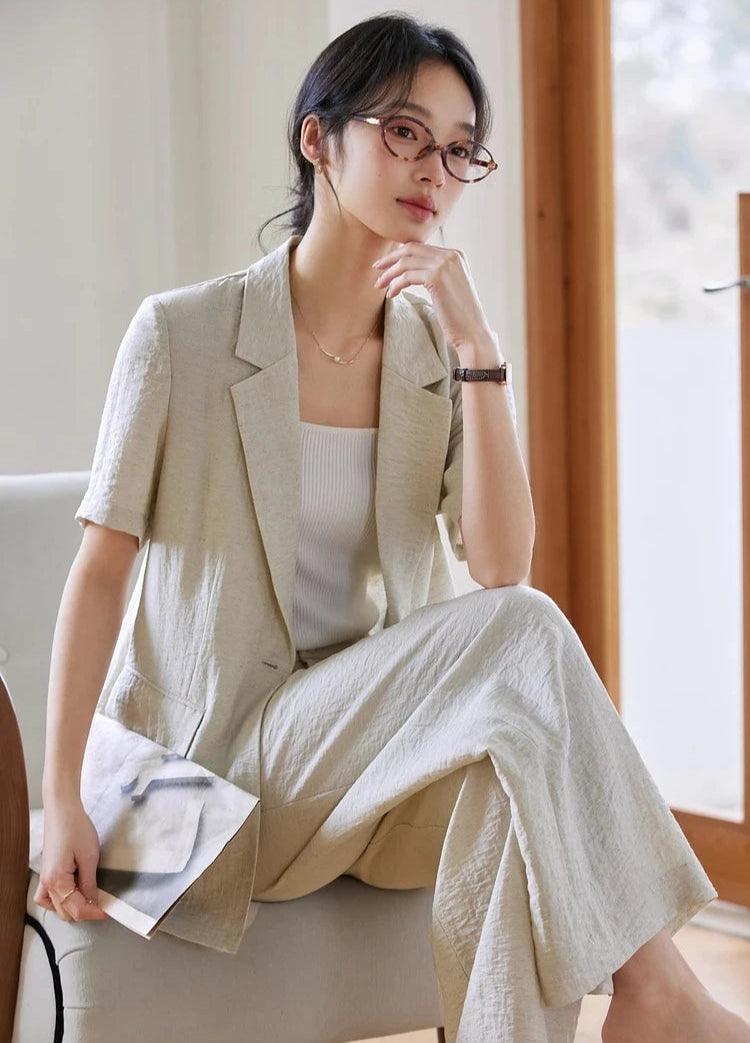 Model in Wild Sand outfit sitting in an armchair, relaxed and composed. From Borcelleclothes.