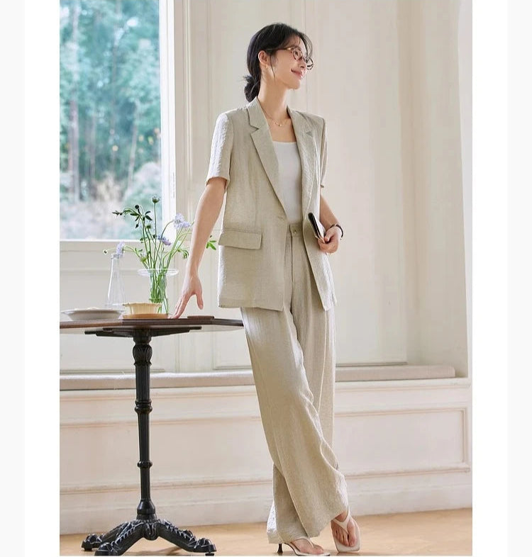 Model gently touching a table while standing in the Wild Sand ensemble. From Borcelleclothes.