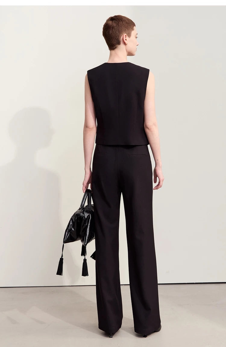 Back view of the woman in Onyx trousers — smooth wool-blend surface, single-welt pockets, and precise structure. — From Borcelleclothes.