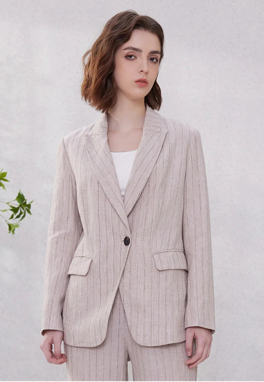 Model wearing women’s woven stripes linen blazer in Pink Swan shade, standing with arms straight. From Borcelleclothes.