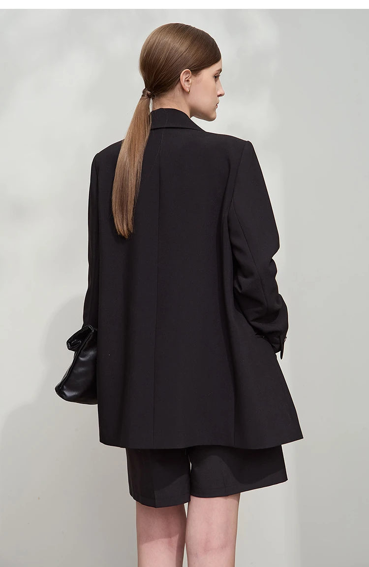 Back view of women’s Onyx wrap blazer with golden pendant – From Borcelleclothes.