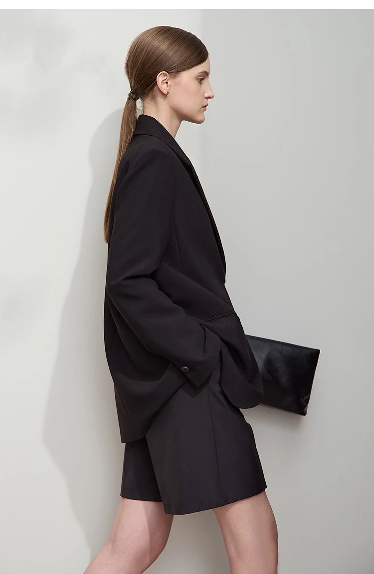 Right side view of women’s Onyx wrap blazer with golden pendant – From Borcelleclothes.