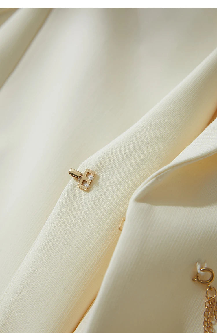 Hidden hook closure on Pearl Bush wrap blazer with golden pendant – From Borcelleclothes.