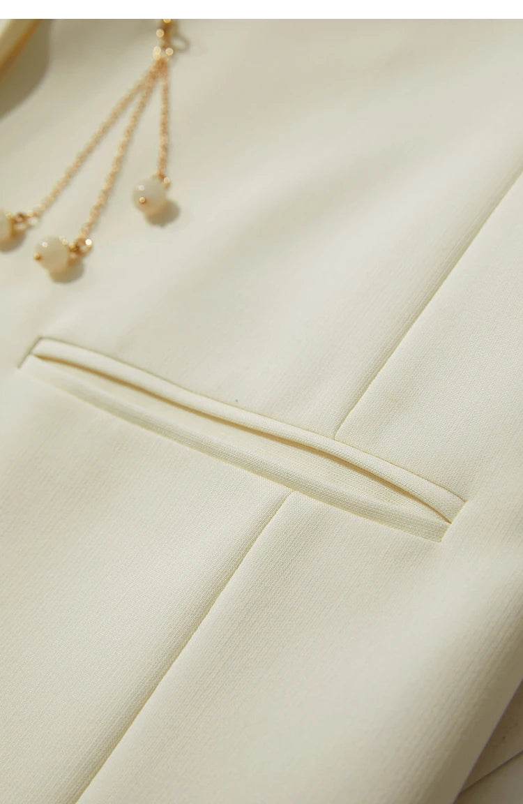 Golden pendant with double-welt pocket on women’s Pearl Bush wrap blazer – From Borcelleclothes.